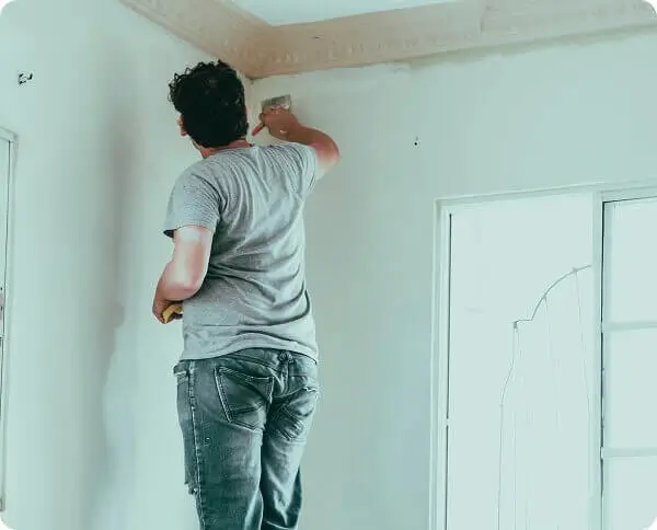 Technician painting a wall